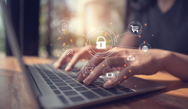 Digital Composite Image Of Businessman Using Laptop With Icons At Desk