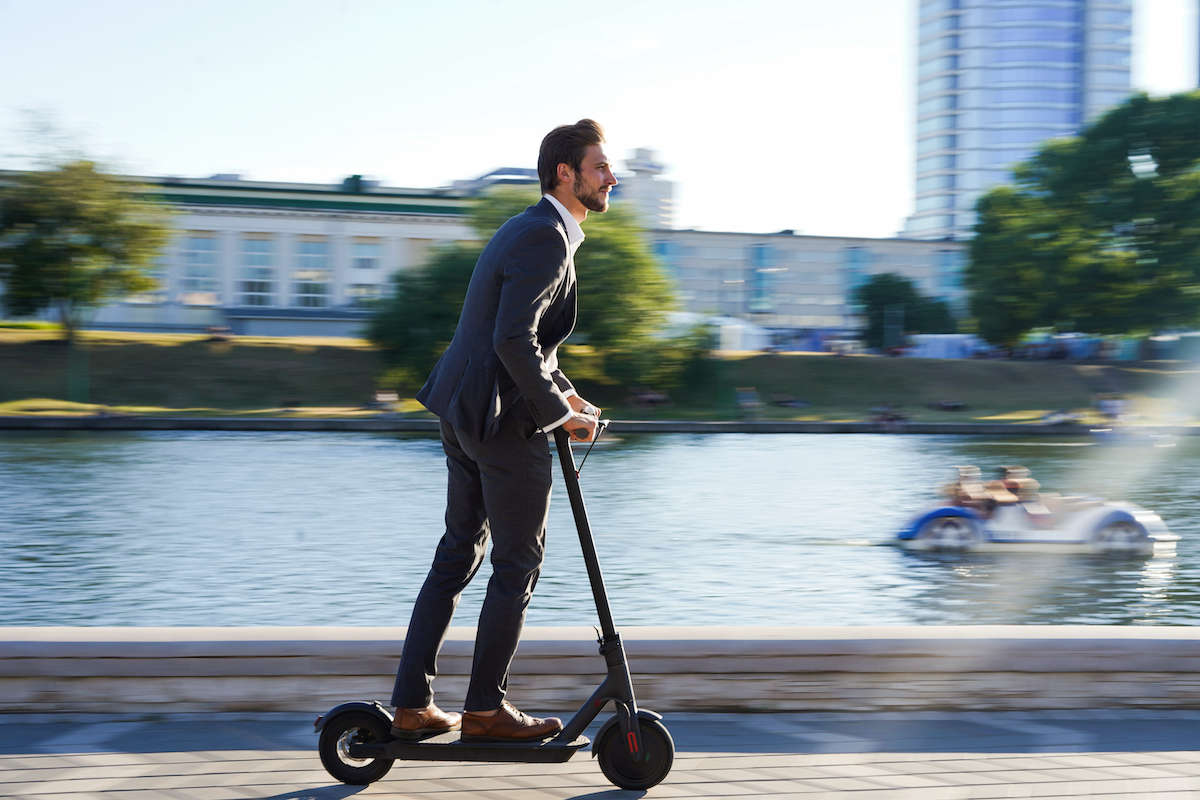 Young,Business,Man,In,A,Suit,Riding,An,Electric,Scooter
